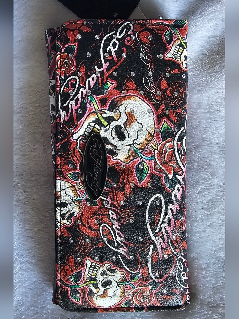 Ed Hardy women's wallet featuring a bedazzled skull and rose tattoo design